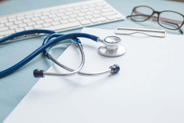 Premium Photo | Stethoscope and medical attributes on the table at the  doctor.