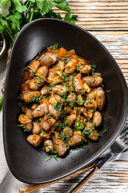 Premium Photo | Stew with chicken hearts and vegetables with fresh parsley