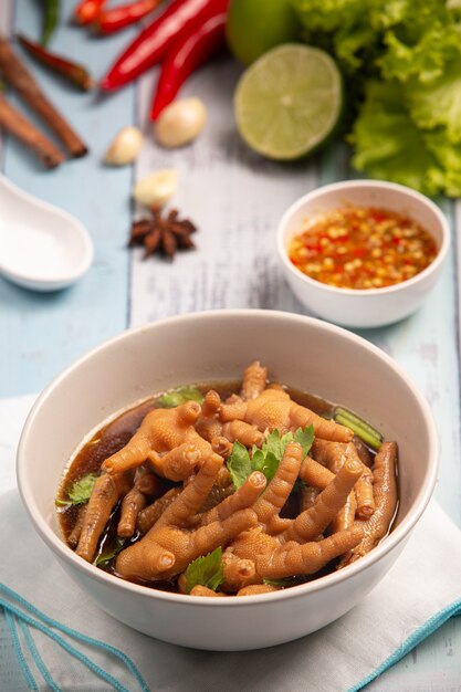 Free Photo | Stewed chicken feet soup served with spicy fish sauce