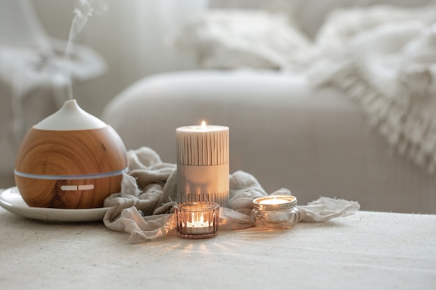 Still life with an aroma diffuser for moisturizing the air and burning candles. Free Photo