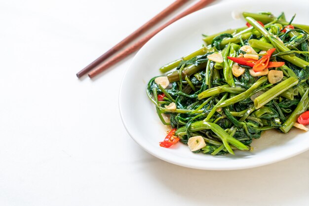 Stir Fried Chinese Morning Glory Or Water Spinach Premium Photo