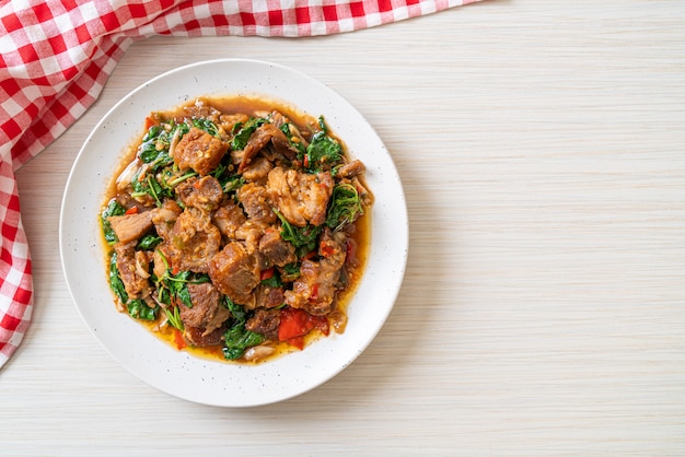 Premium Photo | Stir-fried crispy pork belly and basil