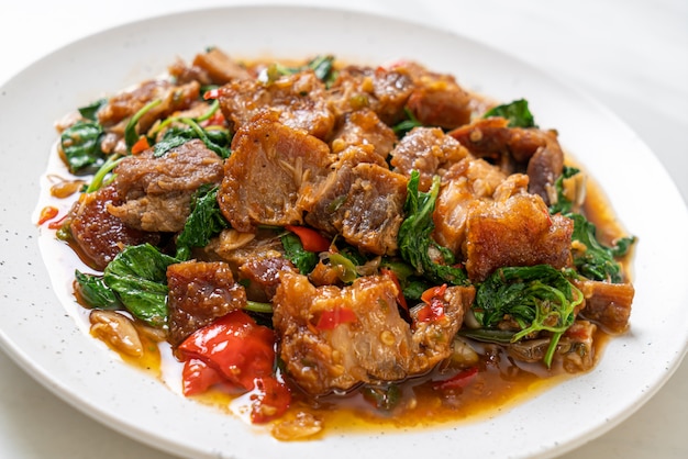 Premium Photo | Stir-fried crispy pork belly and basil