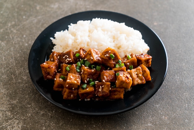 Premium Photo | Stir fried tofu with spicy sauce on rice