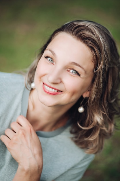 Premium Photo Stock Photo Headshot Of An Attractive Young Woman With Dyed Middle Length Hair With Red Lips And Earrings Smiling At Camera With Happiness Blurred Background