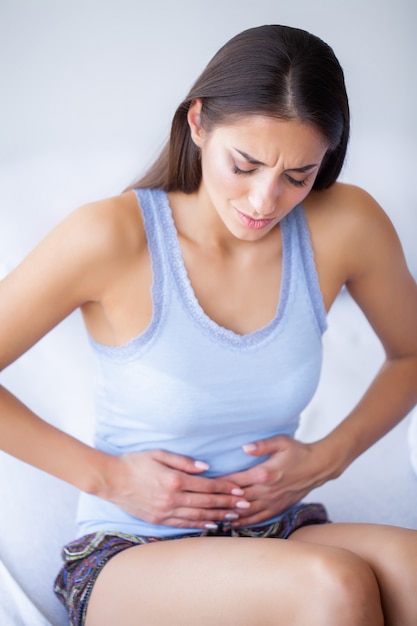 premium-photo-stomach-pain-unhealthy-young-woman-with-stomachache