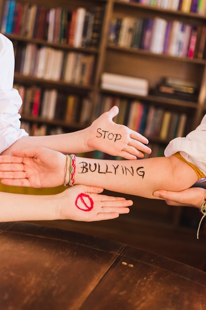Stop bullying slogan on children's arms | Free Photo