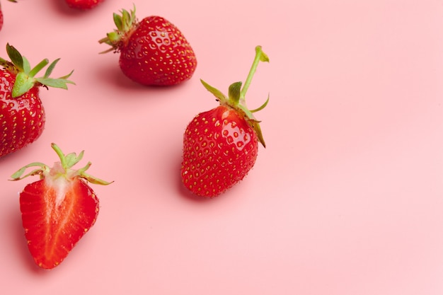 Strawberries on pink background Photo | Premium Download