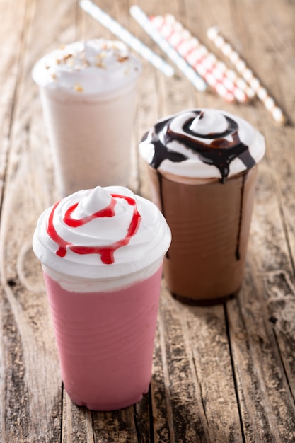 Premium Photo | Strawberry, chocolate, and white iced milkshakes