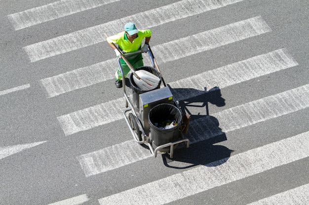 Premium Photo Street Sweeper Pushing A Cart On Crosswalk Public Cleaning Concept