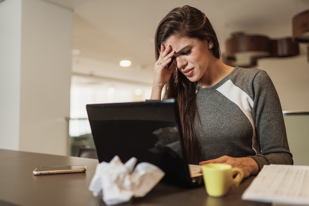 Premium Photo | Stressed latin woman suffering migraine with a laptop