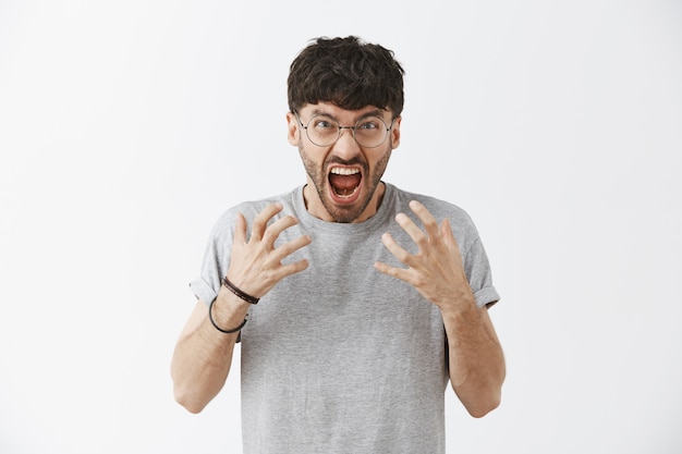 Free Photo | Stressed-out handsome guy posing against the white wall