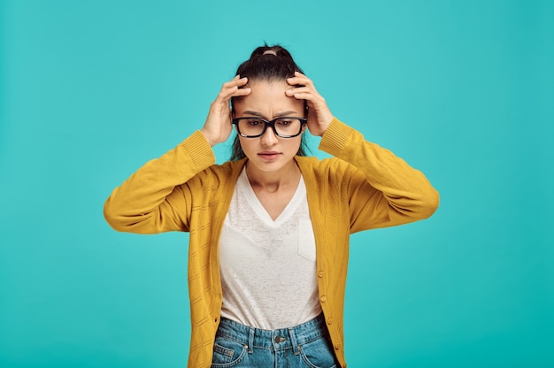 Premium Photo | Stressed woman in glasses, blue wall, negative emotion