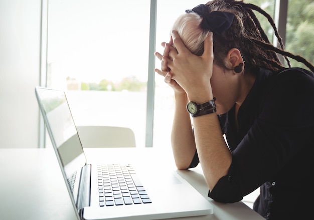 Stressed woman using laptop Free Photo