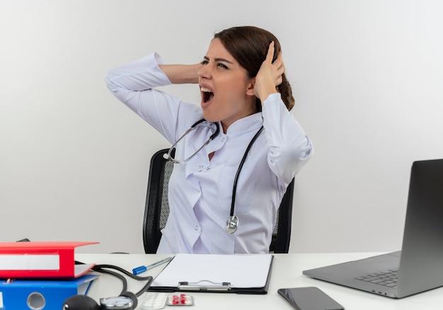 Free Photo Stressed Young Female Doctor Wearing Medical Robe And