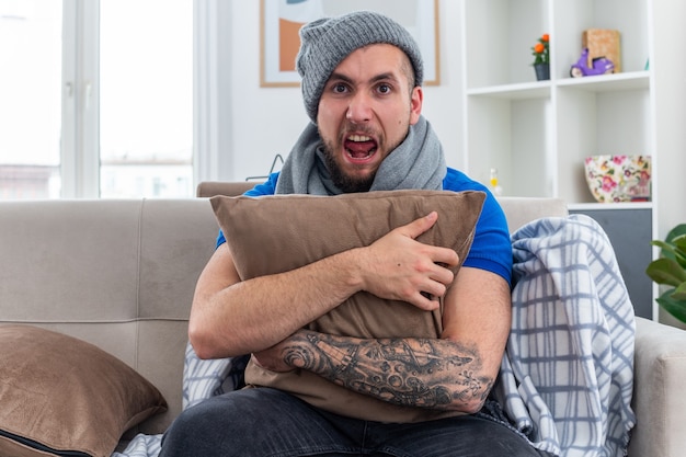 Free Photo | Stressed young ill man wearing scarf and winter hat ...