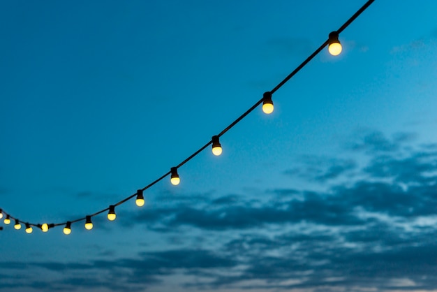 String of lights with sunset sky Photo | Free Download