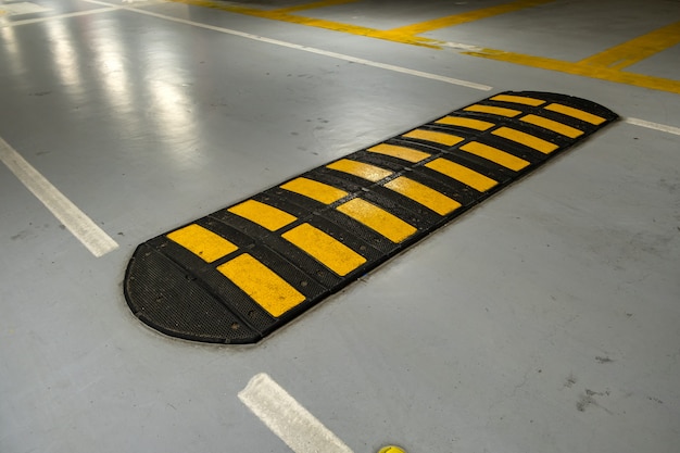 Premium Photo Striped Black And Yellow Speed Bump On A Road