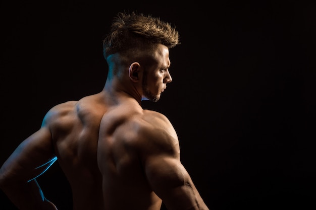 Premium Photo | Strong athletic fitness man posing back muscles