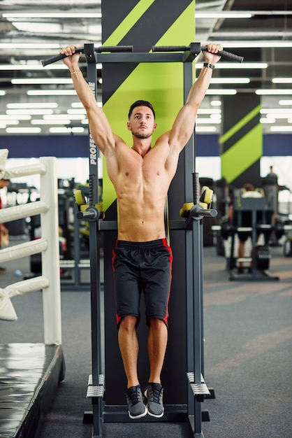 Download Strong attractive man does pull-up on the crossbar during ...