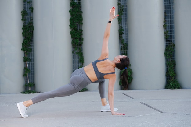 Premium Photo | Strong woman doing yoga on a concrete paving doing ...