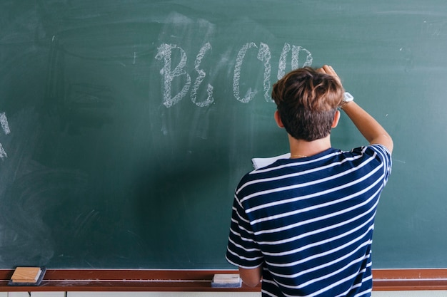 Free Photo | Student Writing On The Blackboard