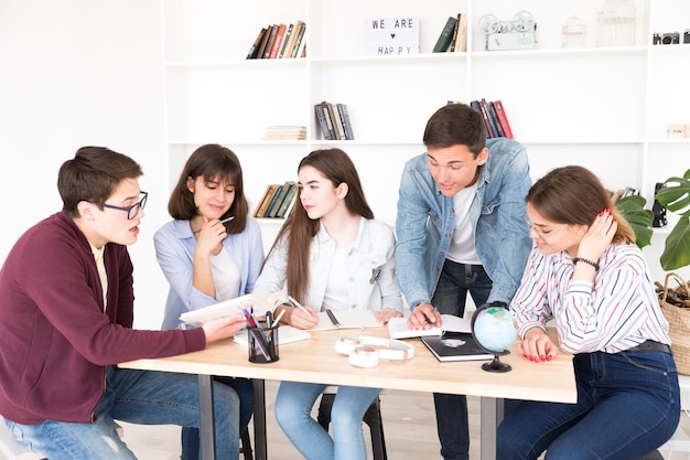 Students At Desk Working Together Free Photo