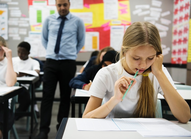 Premium Photo | Students doing the exam in classroom