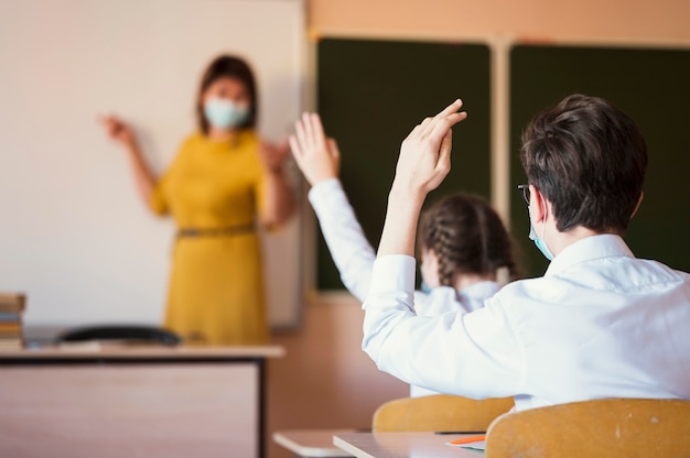 Students and teacher with mask Free Photo