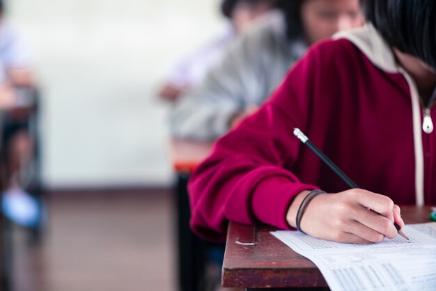 Premium Photo | Students writing and reading exam answer sheets ...