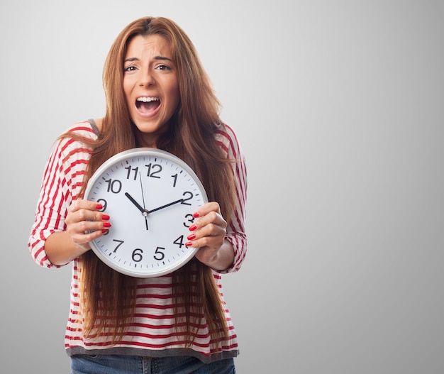 Studio portrait of woman holding big clock Free Photo Studio portrait of woman holding big clock Free Photo
