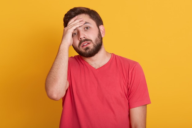 Premium Photo | Studio shot of tensed bearded young man touches his ...