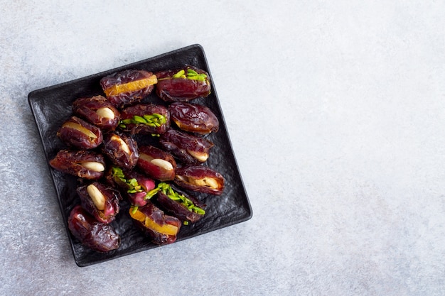 Premium Photo | Stuffed dates with nuts and candied fruit filling