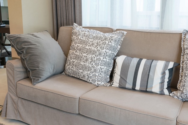 Premium Photo | Sturdy brown tweed sofa with grey patterned pillows