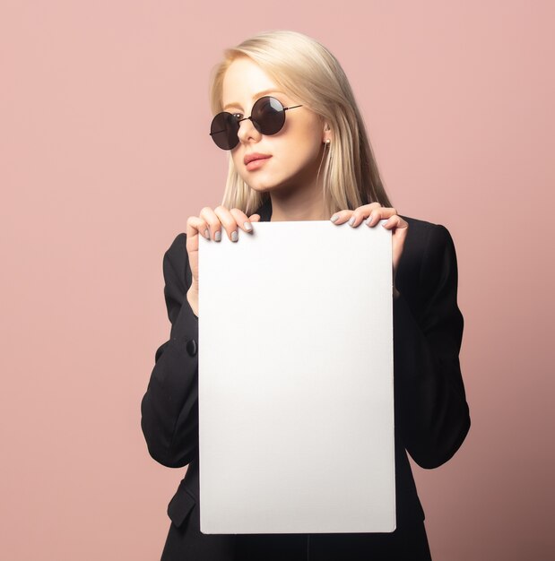 Premium Photo | Style blonde in blazer and sunglasses with paper on