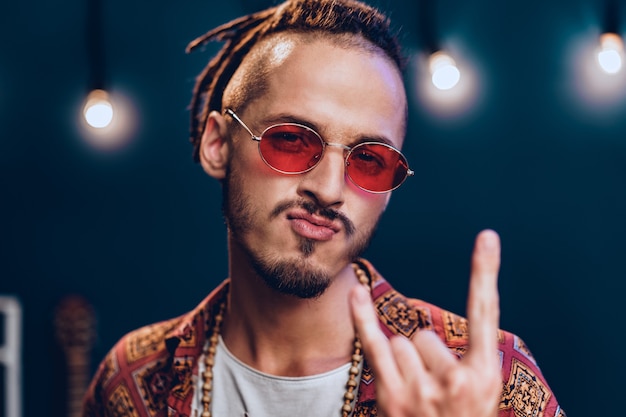 Premium Photo | Stylish guy with dreadlocks wearing pink sunglasses