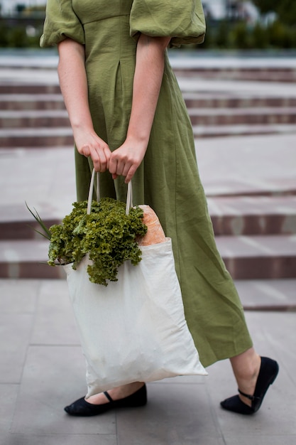 Free Photo | Stylish woman carrying groceries bag