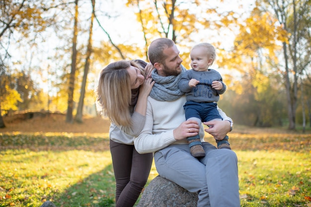 Premium Photo | Stylish young family with their little baby spending ...