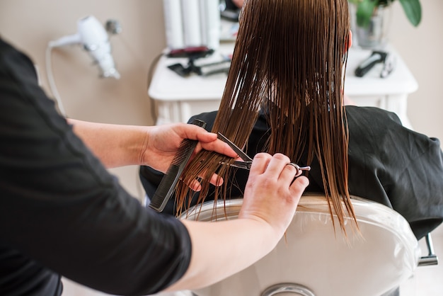 Premium Photo | Stylist hairdresser doing haircut closeup of work equipment