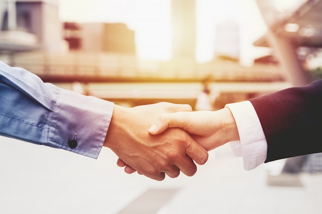 Successful business people handshaking closing a deal ...