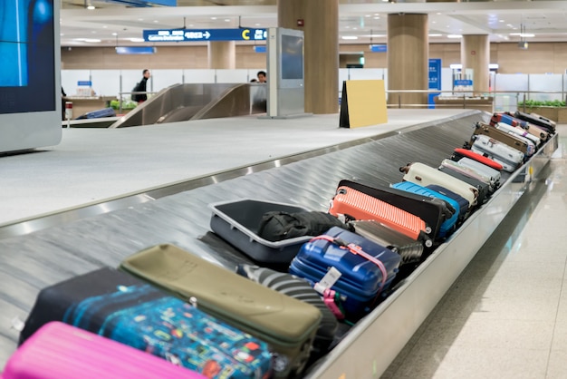 Premium Photo | Suitcase or luggage with conveyor belt in the airport.