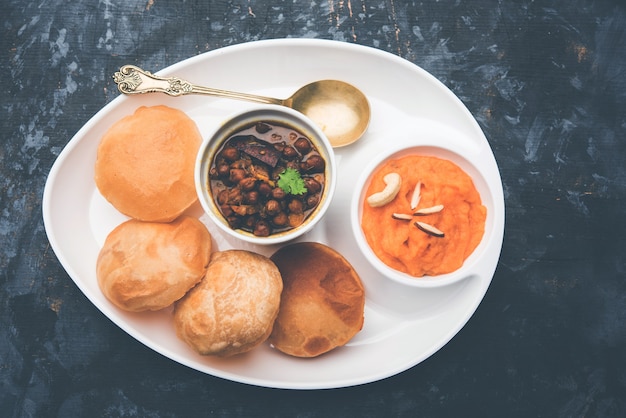 Premium Photo | Suji or sooji halwa puri or sheera or shira poori ...