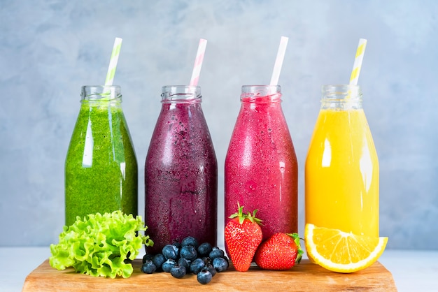 Premium Photo | Summer fruit smoothies in jars with ingredients