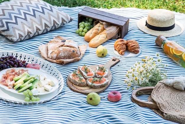 Premium Photo | Summer picnic on the grass, sandwiches with salmon ...