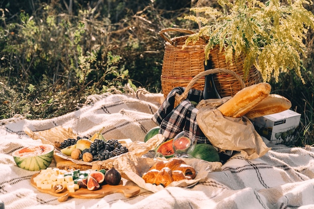 Premium Photo | Summer picnic at sunset on the plaid, food and drink ...