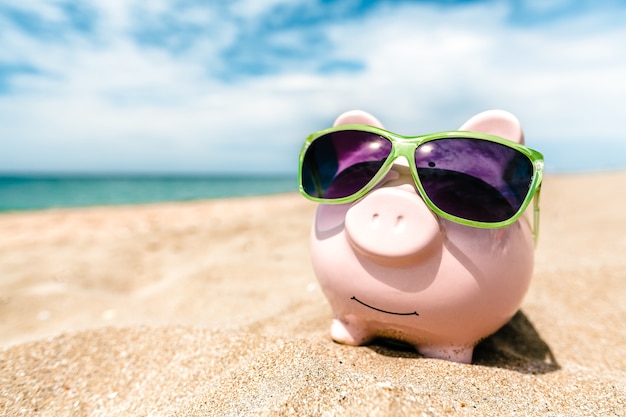 Premium Photo | Summer piggy bank with sunglasses