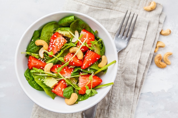 Premium Photo Summer Strawberry Avocado Salad With Cashews In A White Bowl Top View