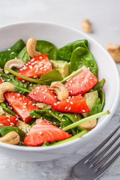 Premium Photo Summer Strawberry Avocado Salad With Cashews In A White Bowl