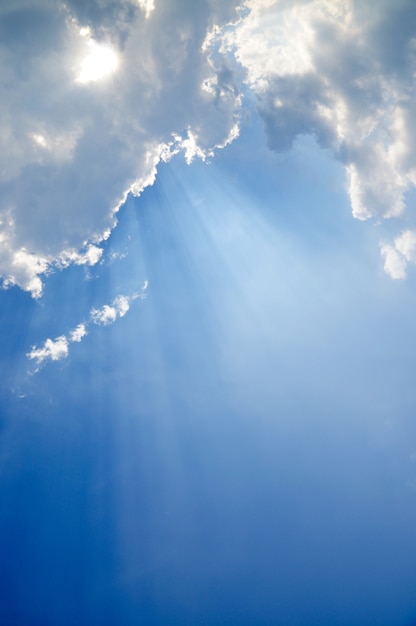 Premium Photo | Sunbeam through the haze on blue sky, clouds with sun rays