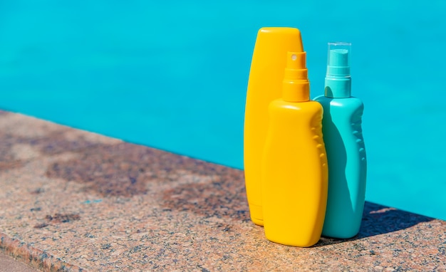 Premium Photo | Sunscreen near the summer pool. selective focus.